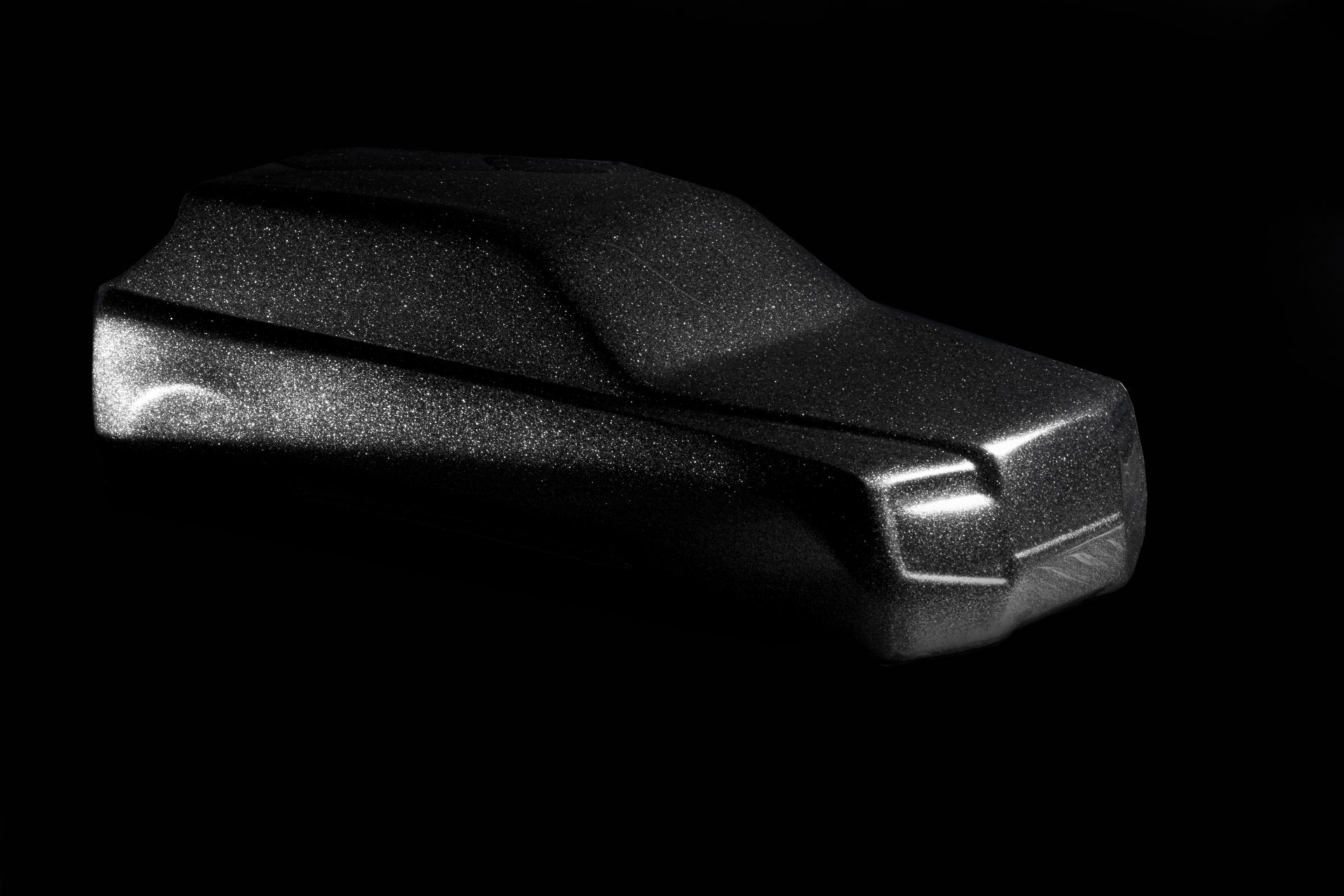 Sculpted form finished in a diamond-dusted surface under low light