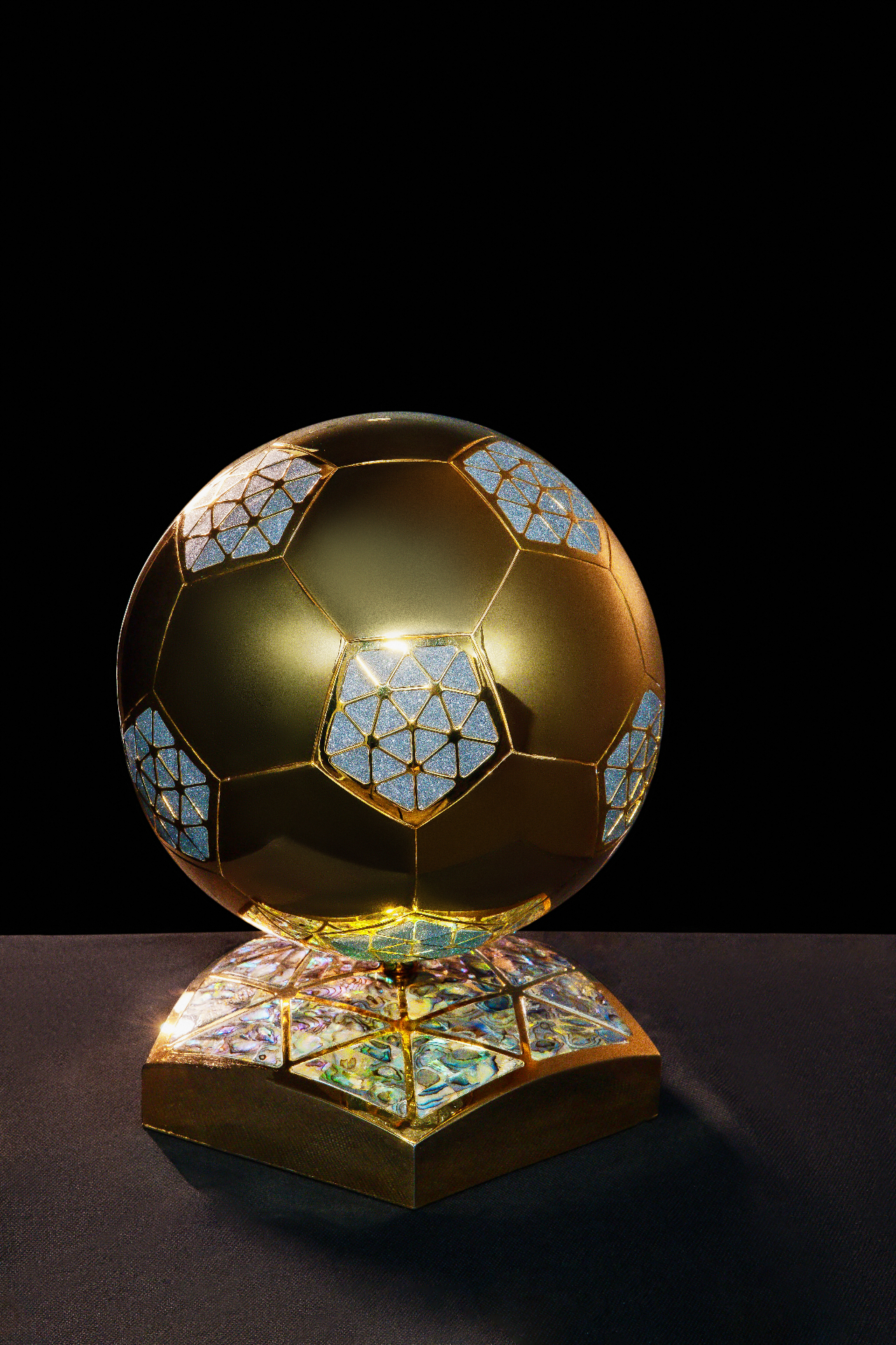 Gold and diamond commemorative football orb on a nacre inlaid base